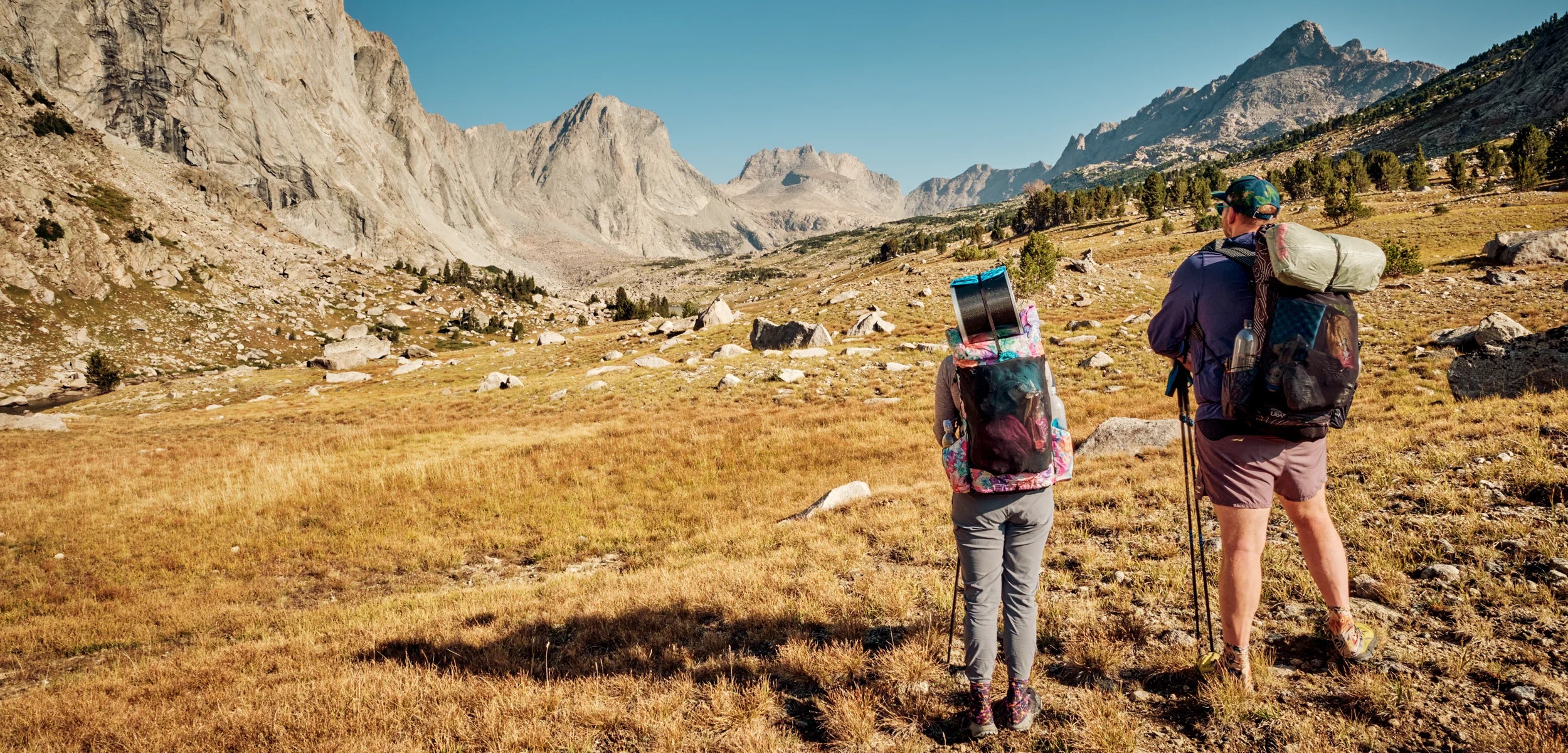 Two backpackers in Wind River mountain range in Wyoming looking towards Raid Peak